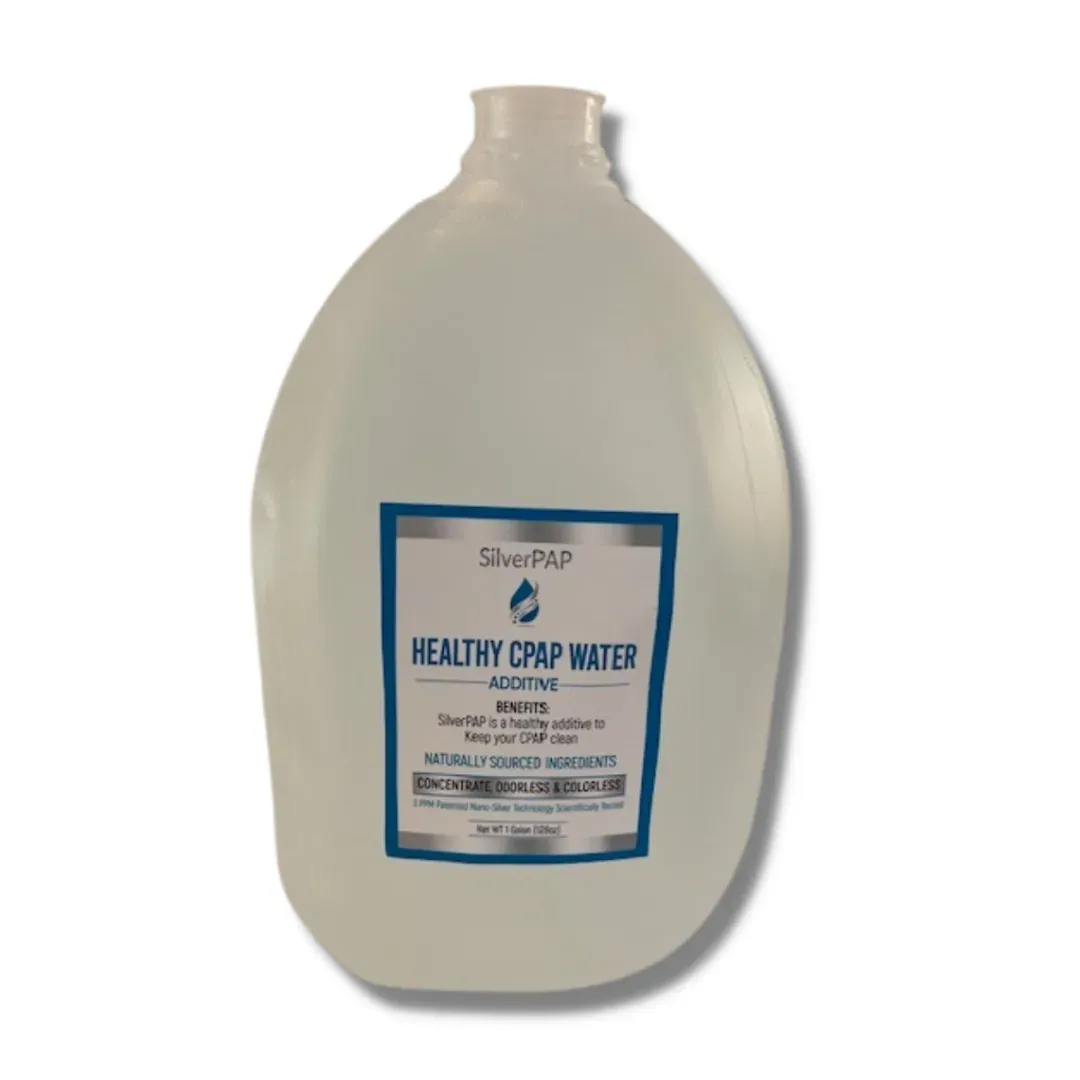 Translucent one gallon jug of SilverPAP CPAP water additive, labelled odorless colorless and naturally sourced